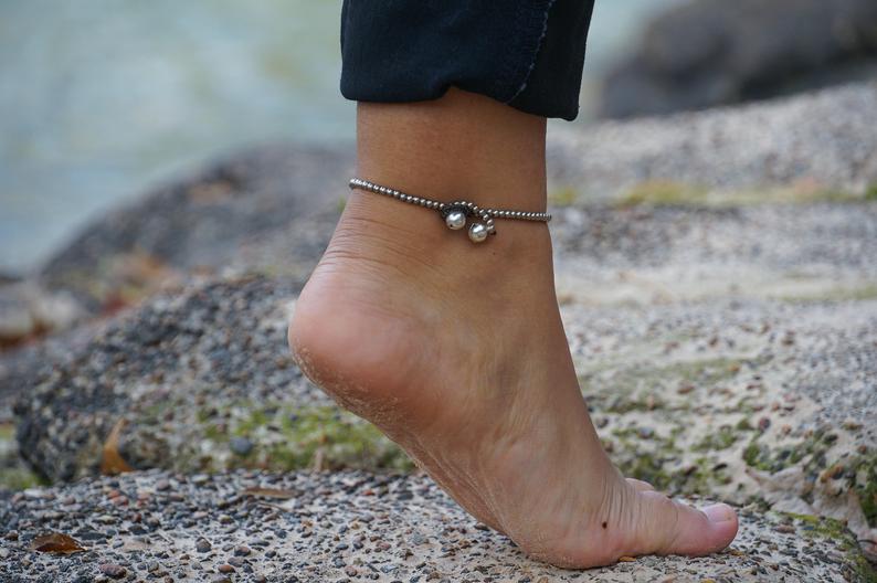 Black Band Boho Silver Anklet featuring silver bells and cotton chords, handcrafted by Thai artisans.