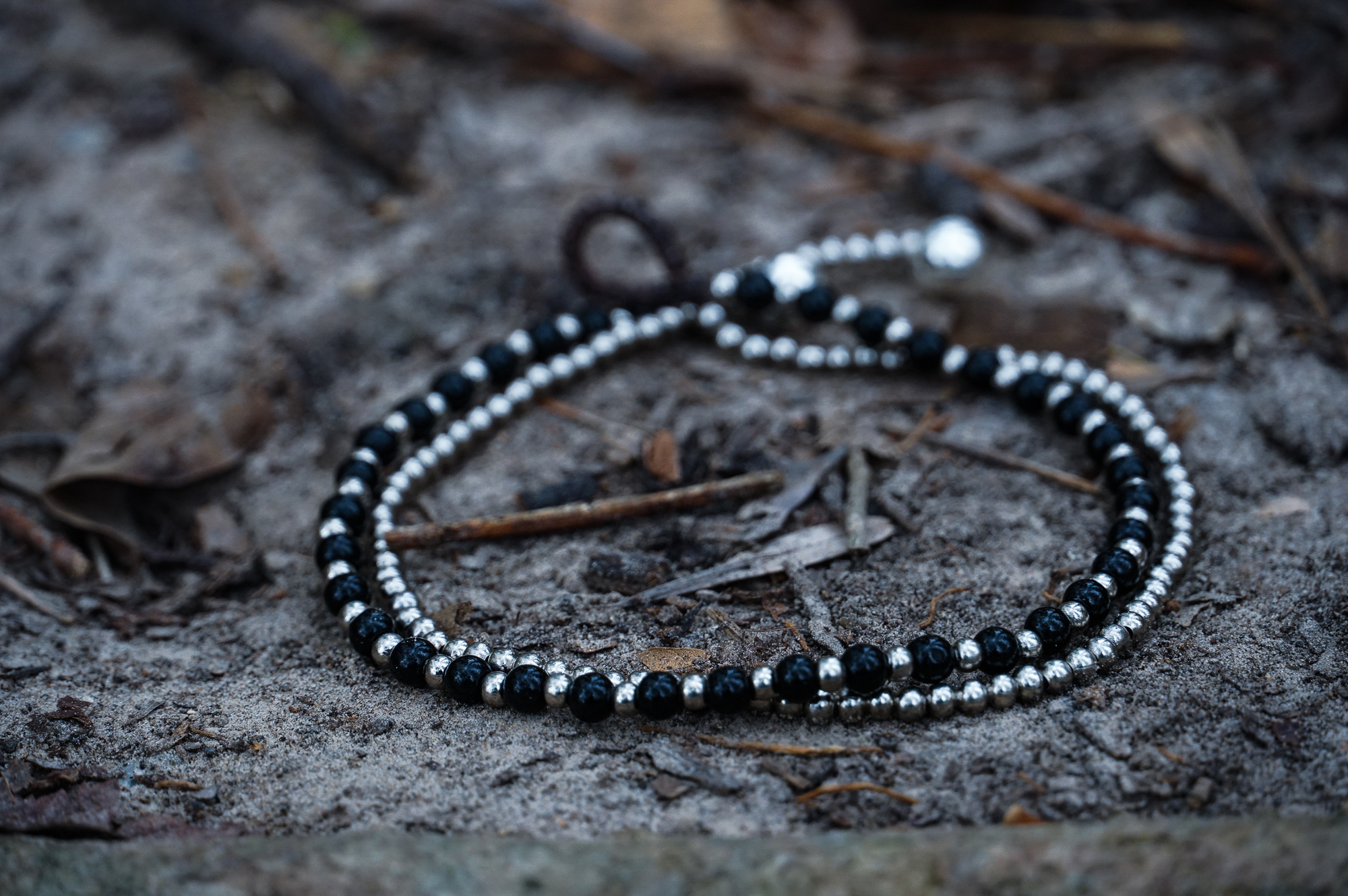 Black Dual Band Boho Silver Anklet featuring silver bells and pressed cotton chords, handcrafted by Thai artisans.