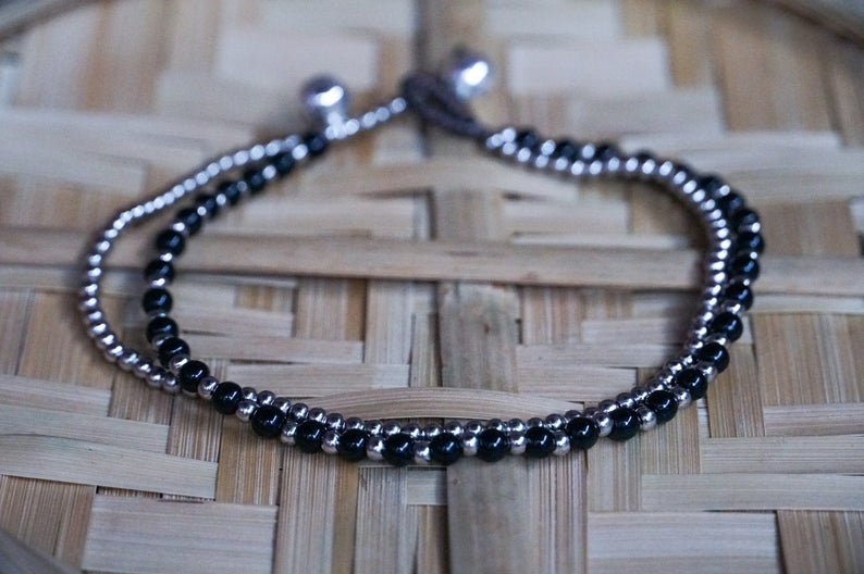 Black Dual Band Boho Silver Anklet featuring silver bells and pressed cotton chords, handcrafted by Thai artisans.