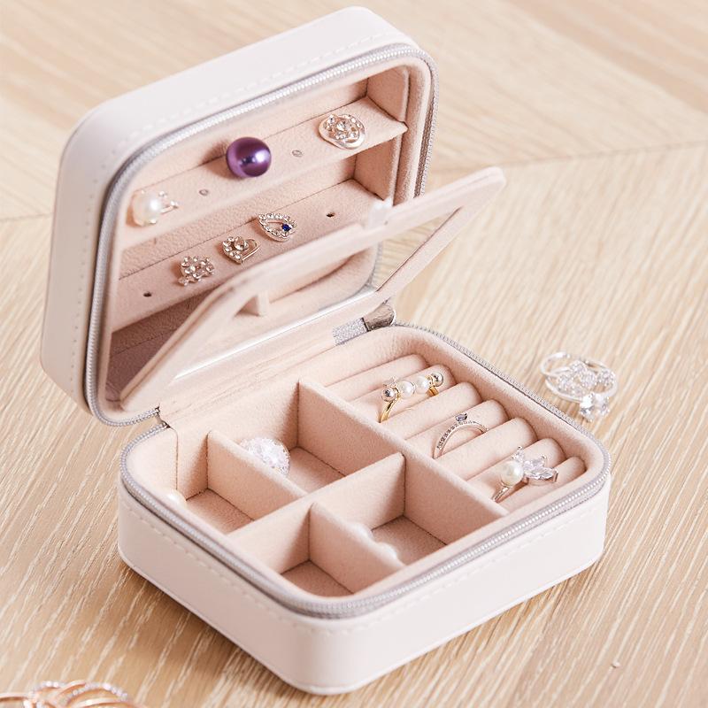 Cool Jewels Palm Sized Compact Jewelry Box in Powder Pink and Sky Blue, featuring vegan leather exterior and suede lining, designed for earrings, rings, and bracelets.