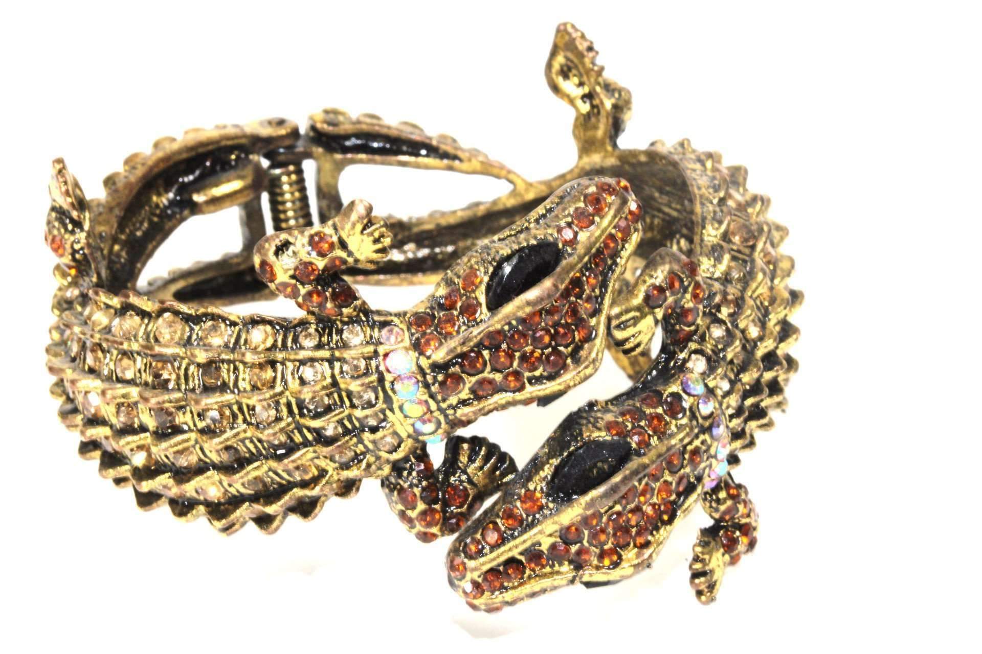 Two bronze tone crocodile hinged bangles adorned with colorful Amber and Aqua rhinestones, showcasing a unique and stylish design.