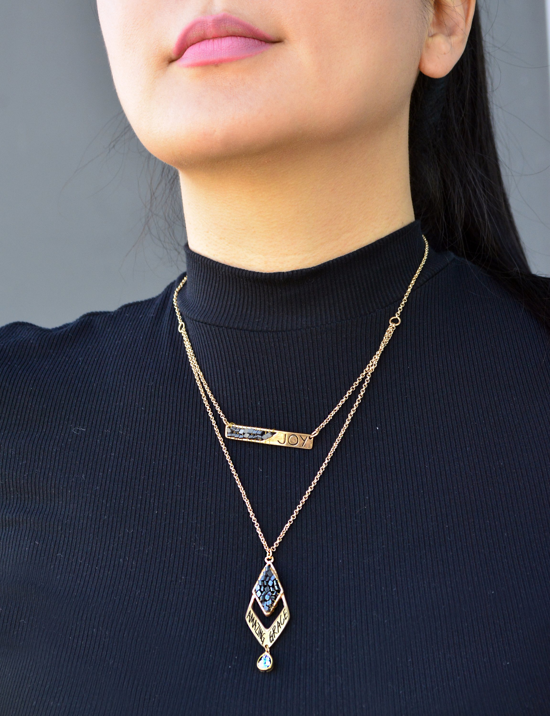 A beautiful diamond necklace featuring joyful inscriptions 'Joy' and 'Amazing Grace', with two layers and hand wired Hematite beads.