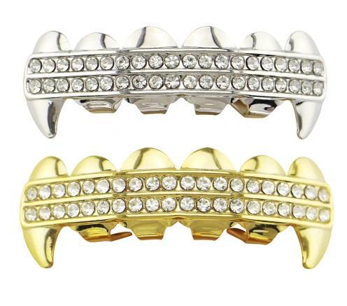 Hip Hop Iced Out Fangs Grillz in Rhodium and Gold plating, displayed in an acrylic box with wax/mold for fitting.