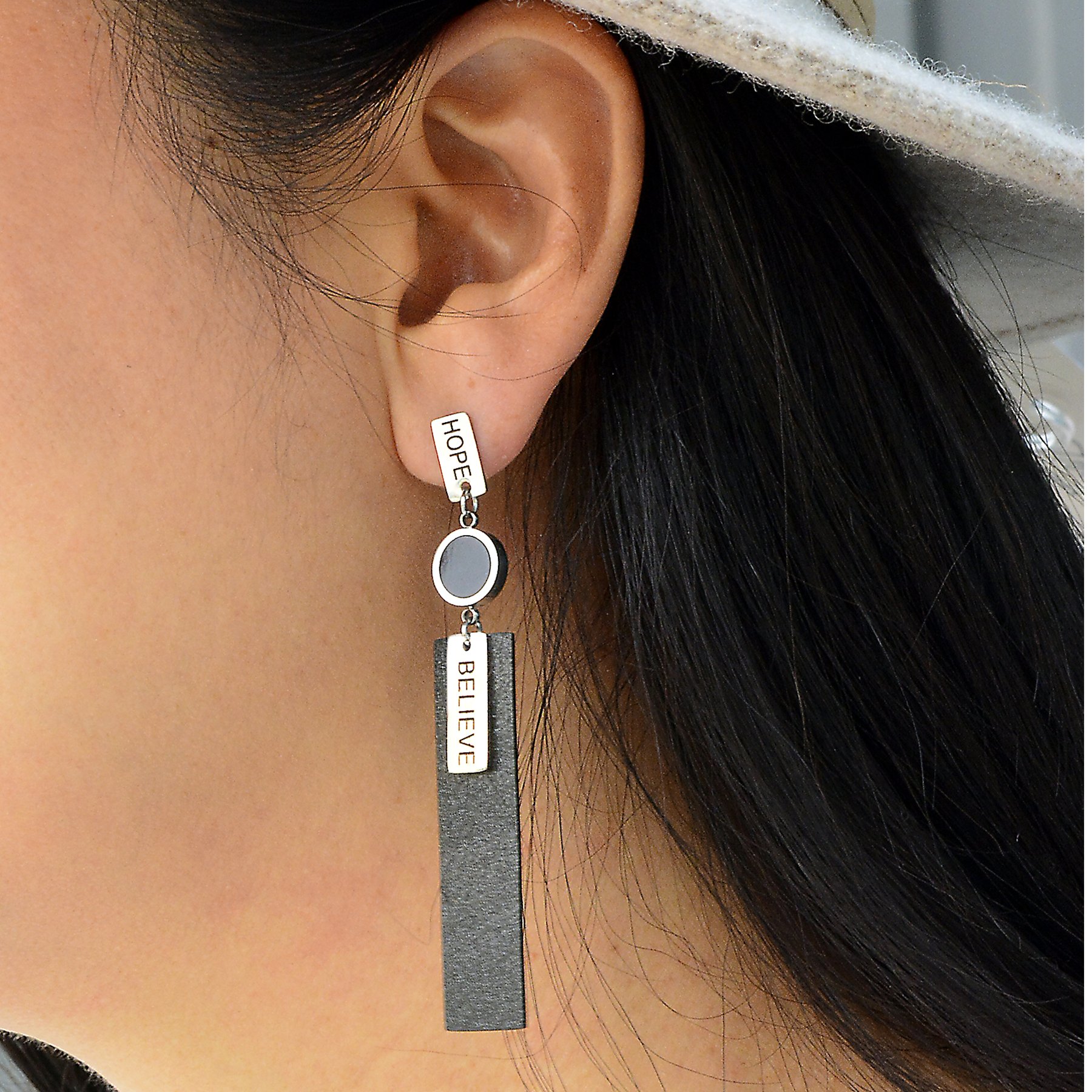 A pair of elegant Hope Earrings made from white brass, featuring a stud closure and a length of 2.8 inches, symbolizing hope and belief.