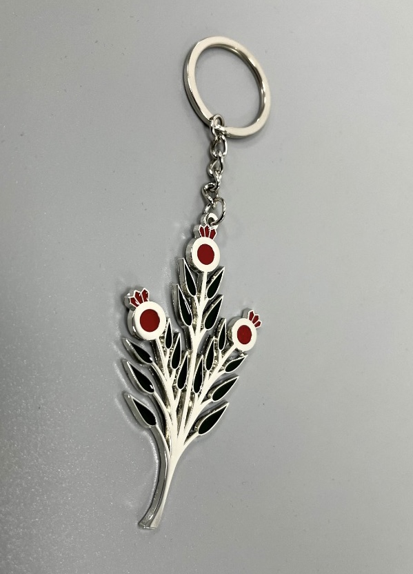 A detailed Pomegranate Branch Keychain made of silver-coated copper, featuring an elegant design of pomegranate branches and fruits.