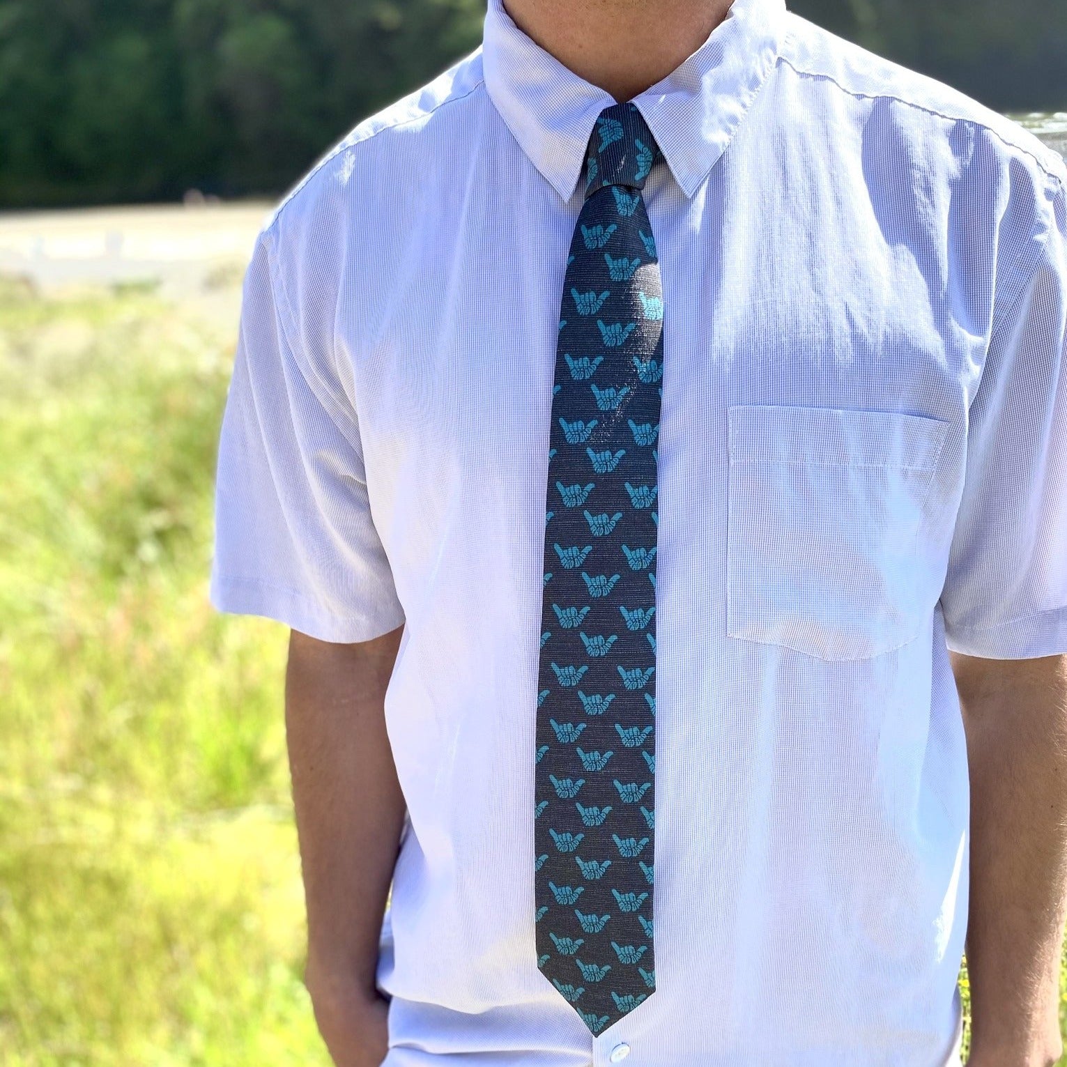 Turquoise Rad Dad Shaka tie featuring a stylish design, water-repellent and stain-resistant fabric.