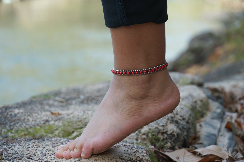 Red Band Boho Silver Anklet featuring silver bells and cotton chords, handcrafted by Thai artisans, perfect for bohemian style.