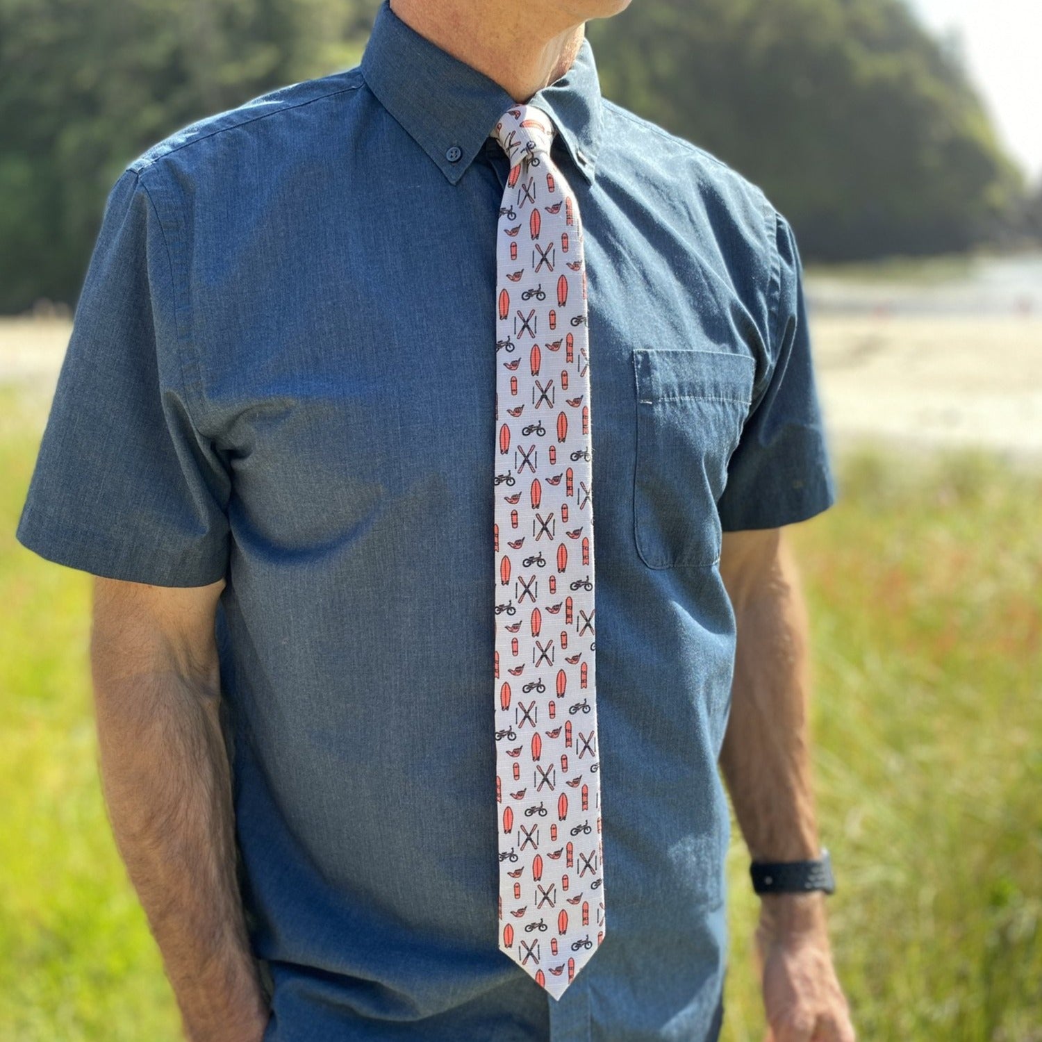 Coral tie from Tools of the Trade, featuring a stylish design with water-repellent and stain-resistant properties, perfect for shredders.