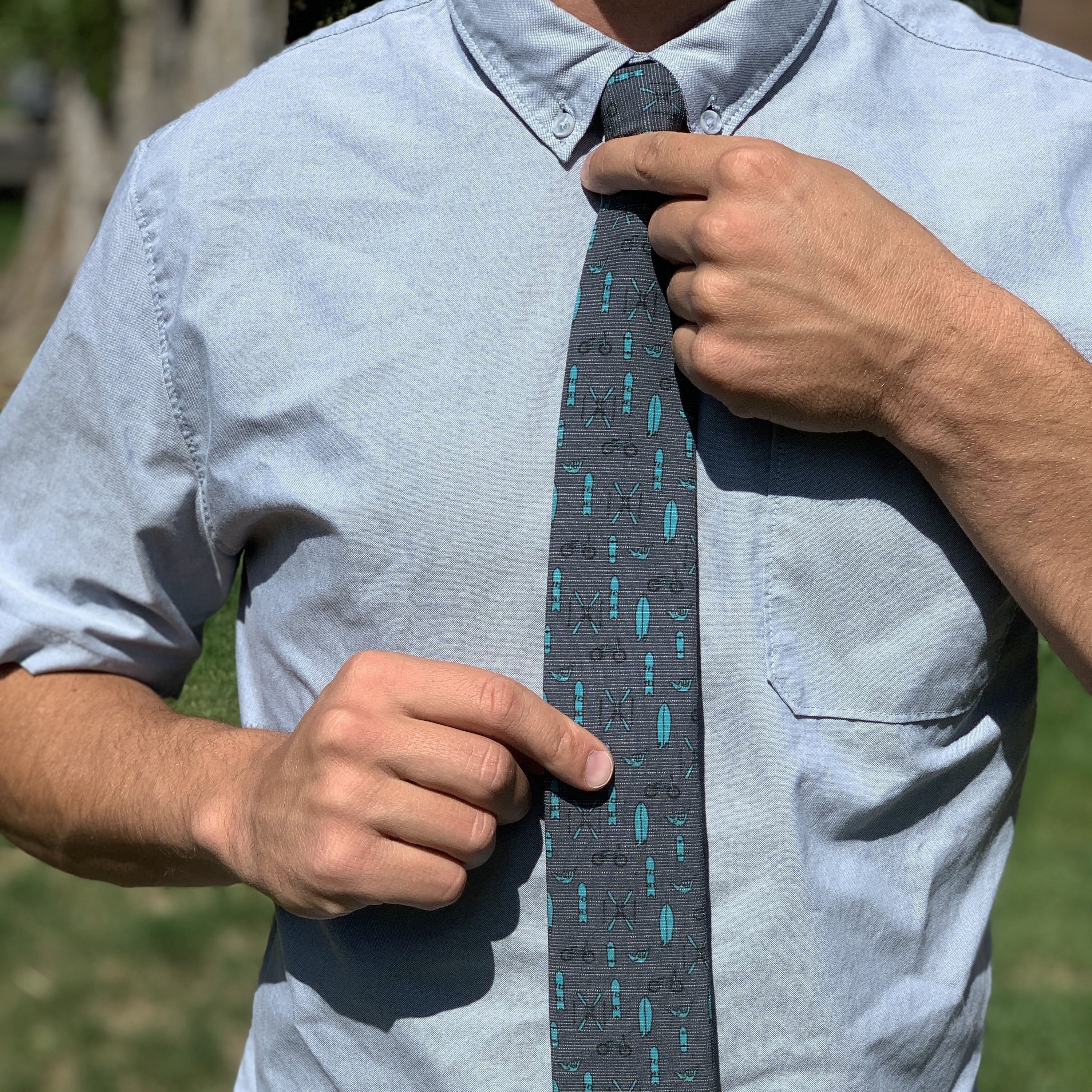 Turquoise Tools of the Trade tie, featuring a stylish design, water-repellent and stain-resistant fabric, perfect for shredders.