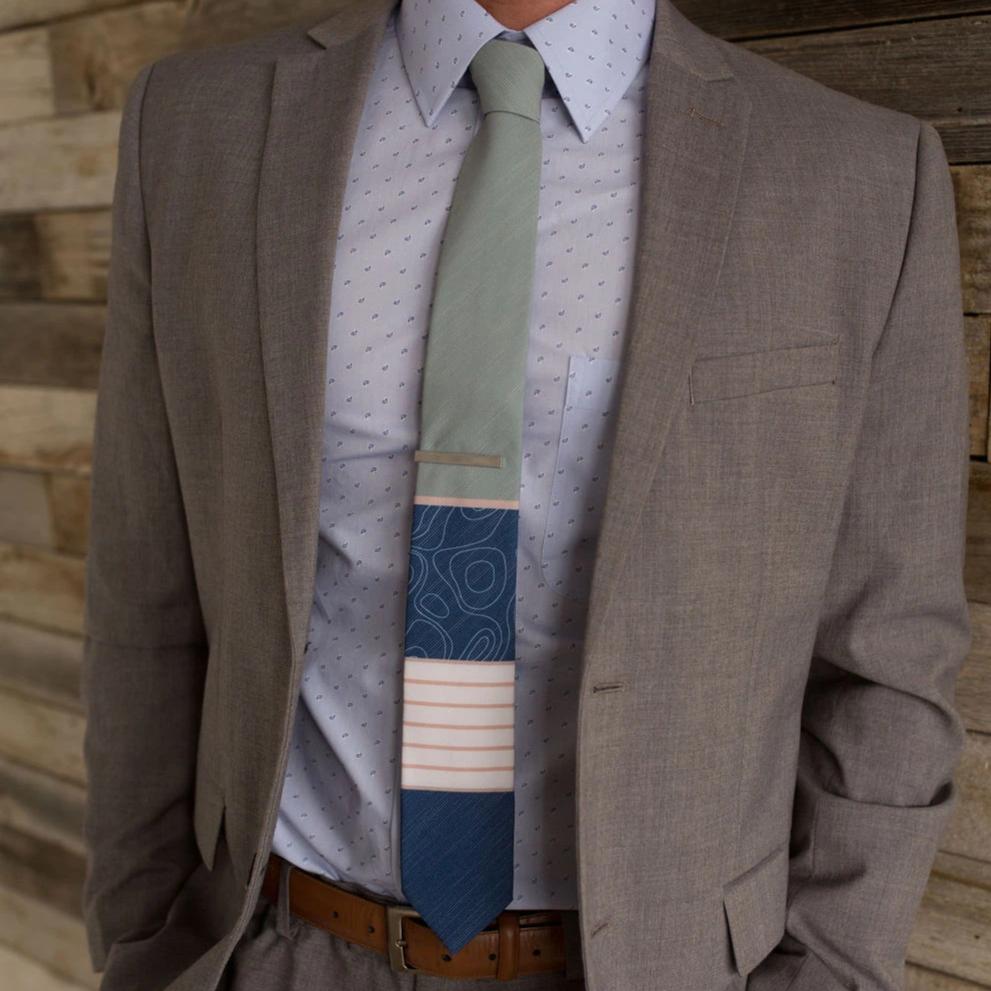 Man wearing suit with colorful tie.