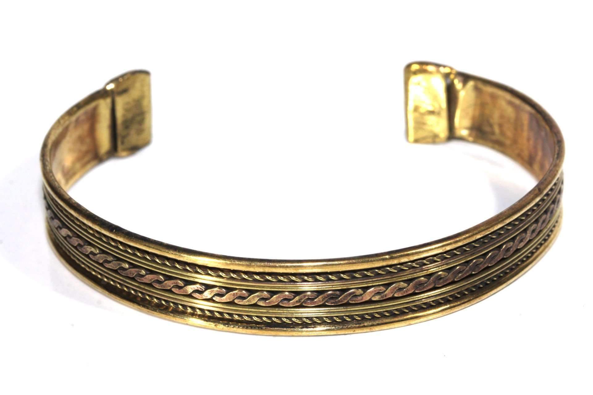 A beautifully crafted Tribal Cuff Bangle in bronze and brass tones featuring intricate handmade scroll work designs, adjustable for a perfect fit.