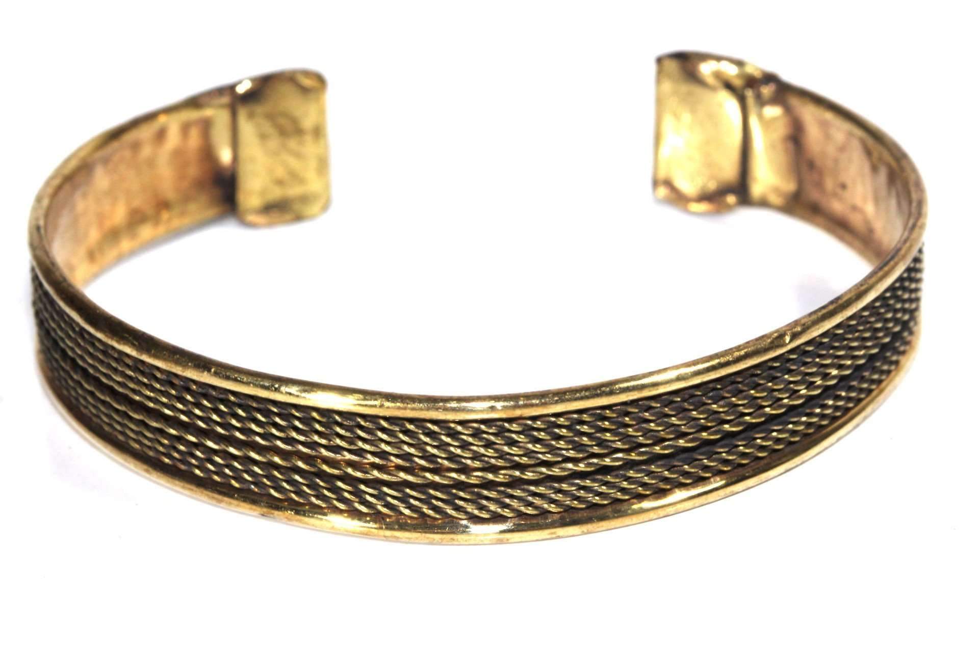 A beautifully crafted Tribal Cuff Bangle in bronze and brass tones featuring intricate handmade scroll work designs, adjustable for a perfect fit.