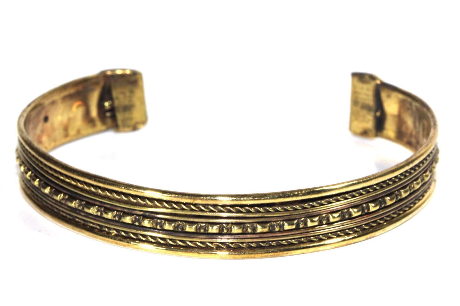 A beautifully crafted Tribal Cuff Bangle in bronze and brass tones featuring intricate handmade scroll work designs, adjustable for a perfect fit.