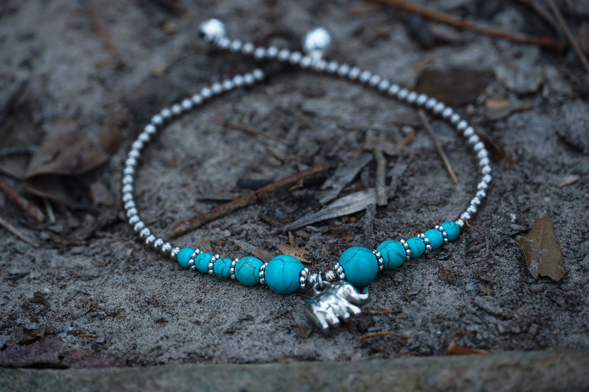 Turquoise Elephant Pendant Boho Silver Anklet featuring silver bells and pressed cotton chords, perfect for bohemian style.