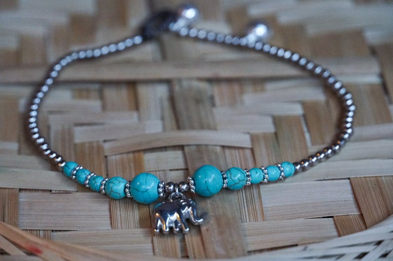 Turquoise Elephant Pendant Boho Silver Anklet featuring silver bells and pressed cotton chords, perfect for bohemian style.