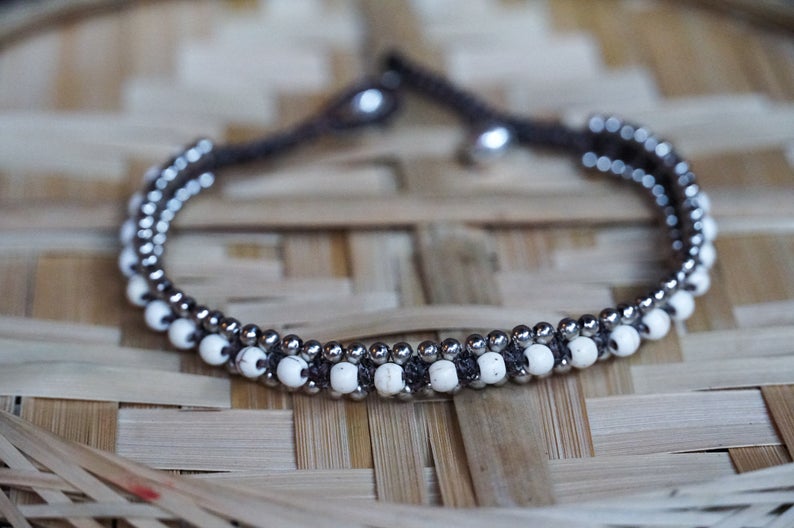 White Band Boho Silver Anklet featuring cotton chords, silver bells, and stone accents, handcrafted by Thai artisans.