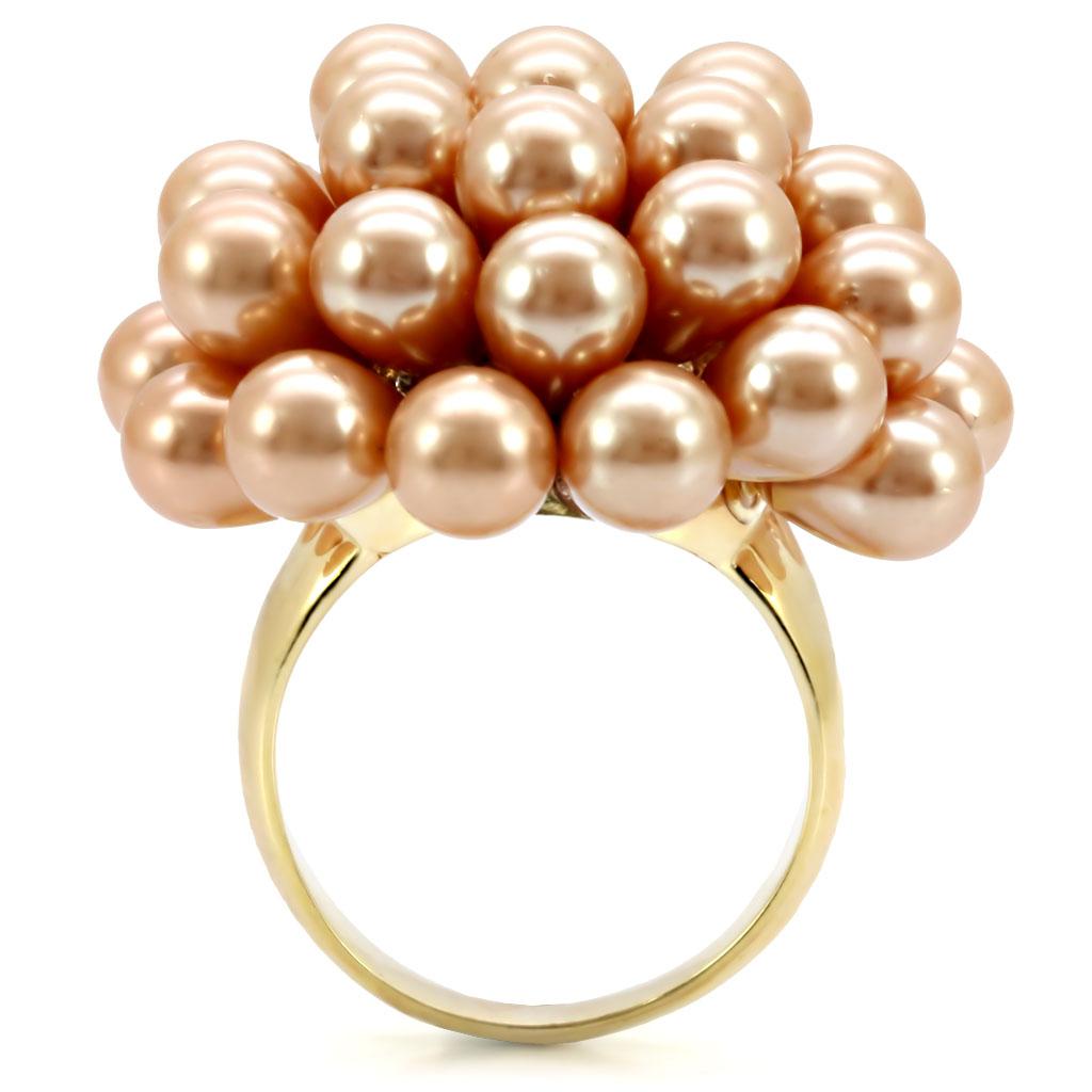 Elegant gold brass ring featuring a champagne synthetic pearl, showcasing its luxurious design and craftsmanship.