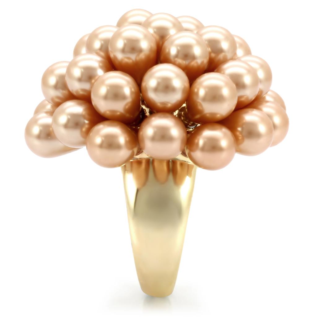 Elegant gold brass ring featuring a champagne synthetic pearl, showcasing its luxurious design and craftsmanship.