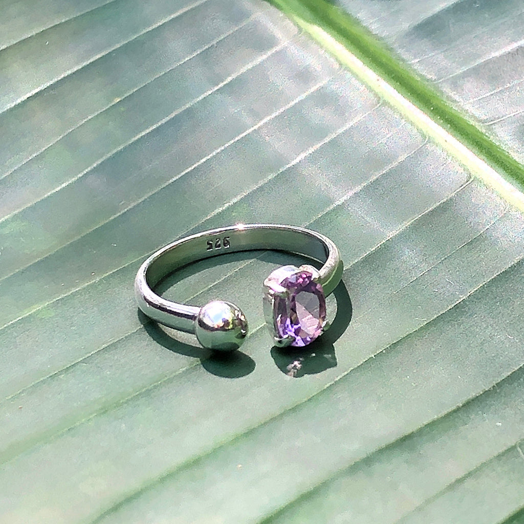 A beautiful Amethyst Ball Ring featuring a sparkling open wrap design, crafted from amethyst and sterling silver, showcasing its unique craftsmanship.