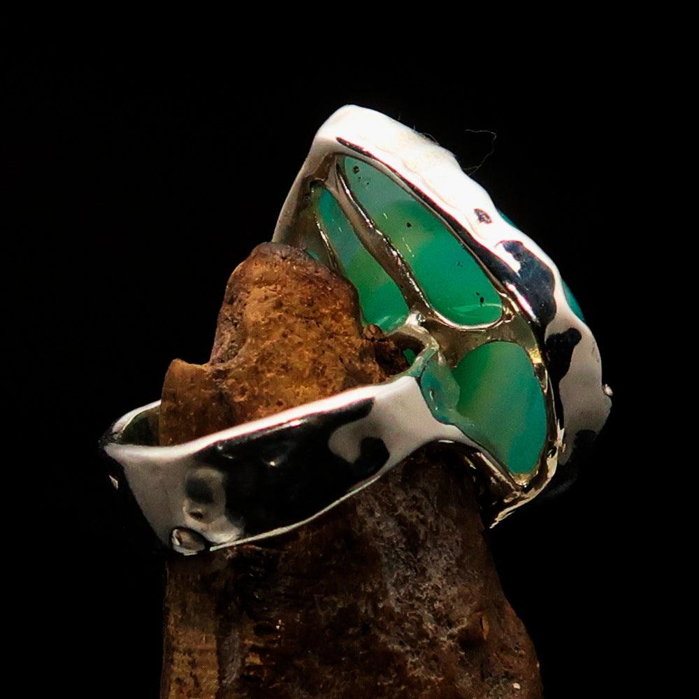 Artistic sterling silver ring featuring a pear-shaped green Agate cabochon, showcasing its elegant design and polished finish.