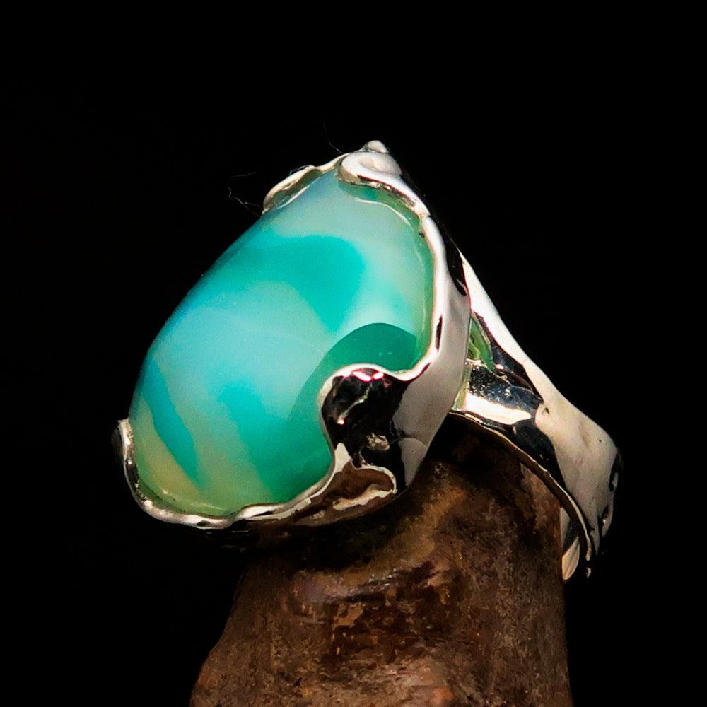 Artistic sterling silver ring featuring a pear-shaped green Agate cabochon, showcasing its elegant design and polished finish.