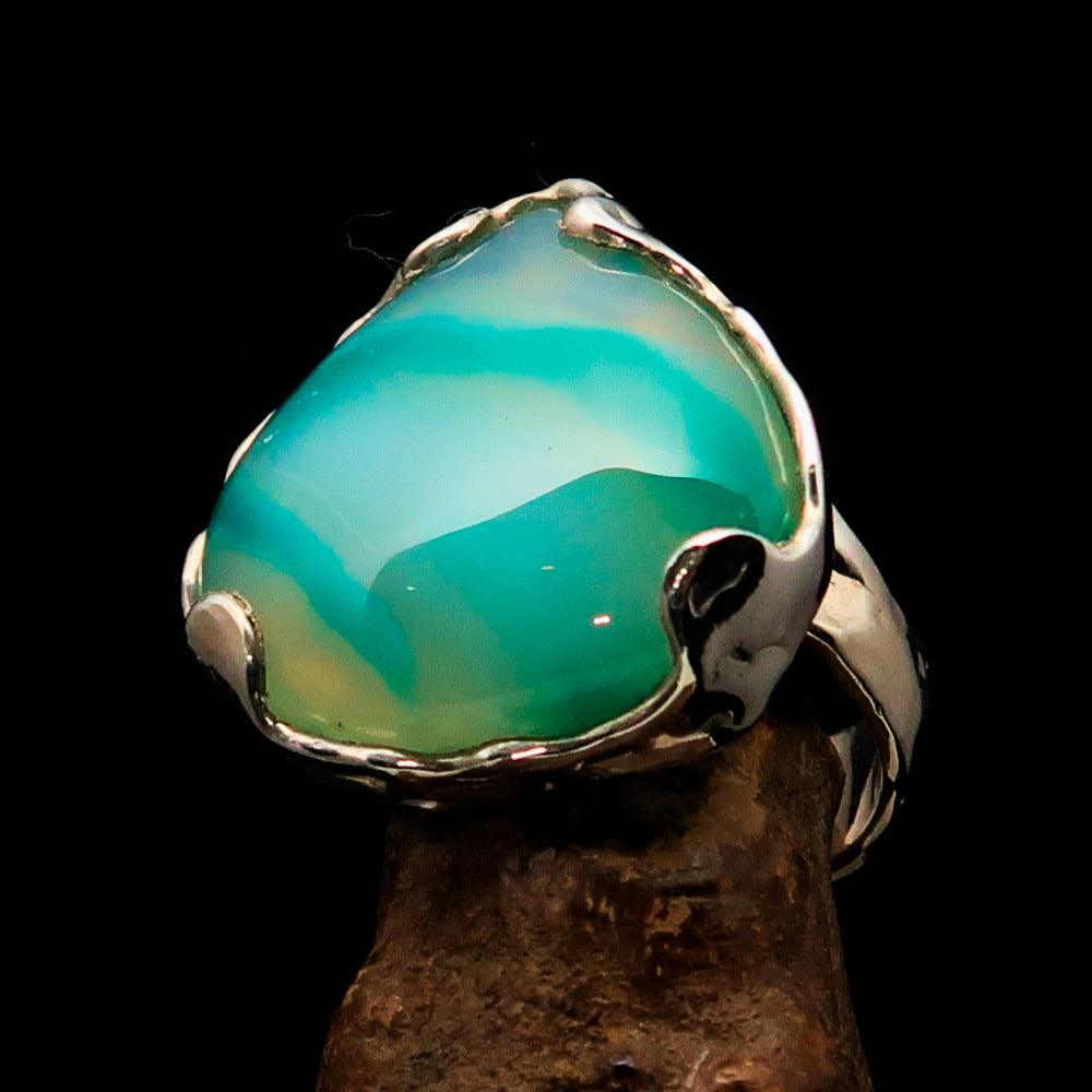 Artistic sterling silver ring featuring a pear-shaped green Agate cabochon, showcasing its elegant design and polished finish.