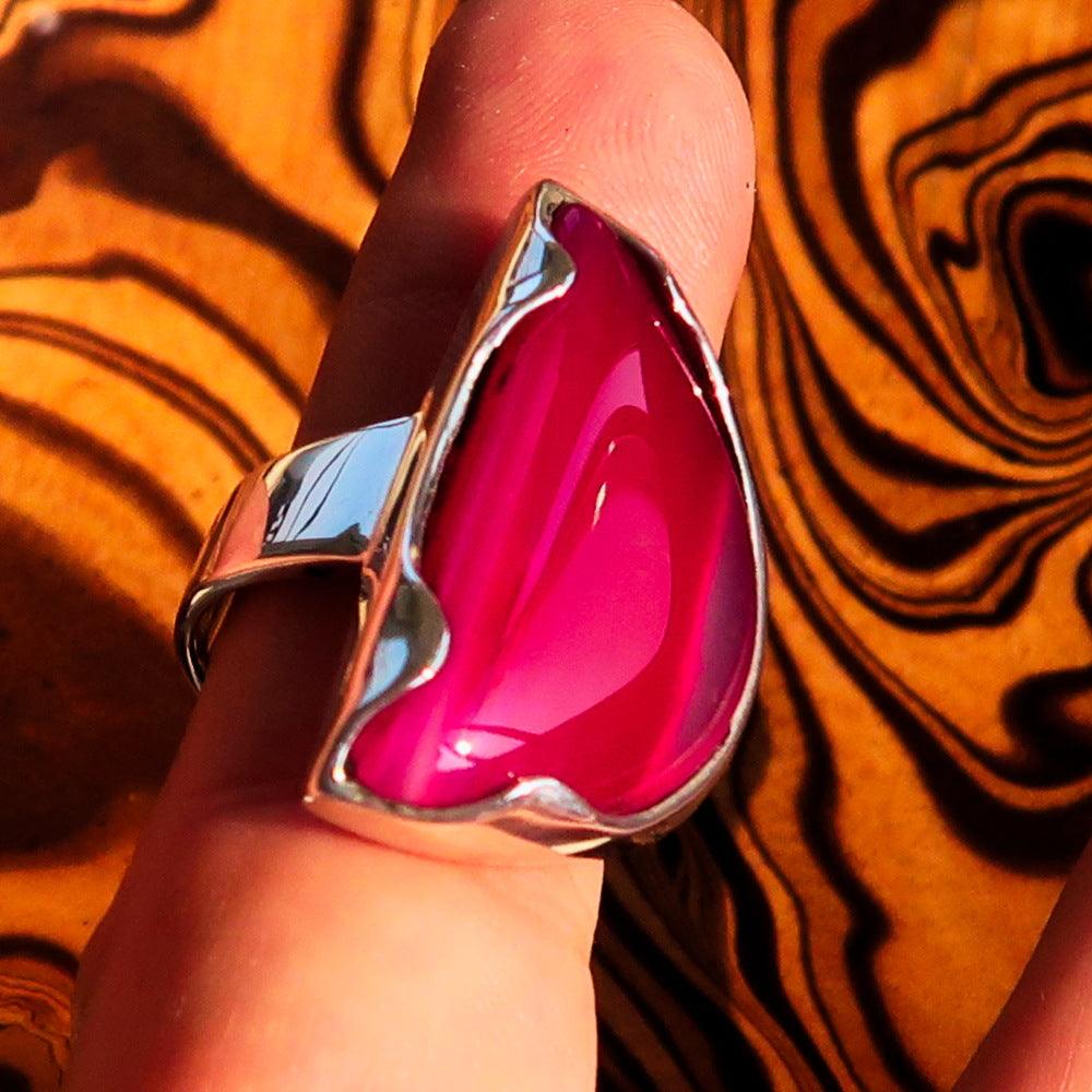 Asymmetric Sterling Silver Ring featuring a fancy shaped pink Agate Cabochon, showcasing its unique design and polished finish.