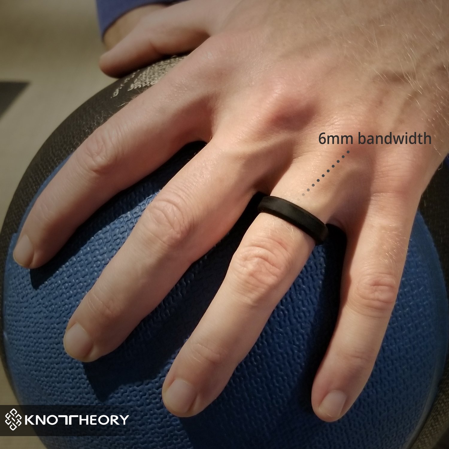 Black silicone wedding ring with a beveled edge, designed for comfort and style, suitable for both men and women.