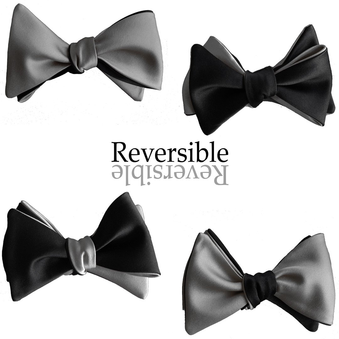 A sophisticated black and slate grey reversible butterfly bow tie, showcasing its elegant design and versatility.