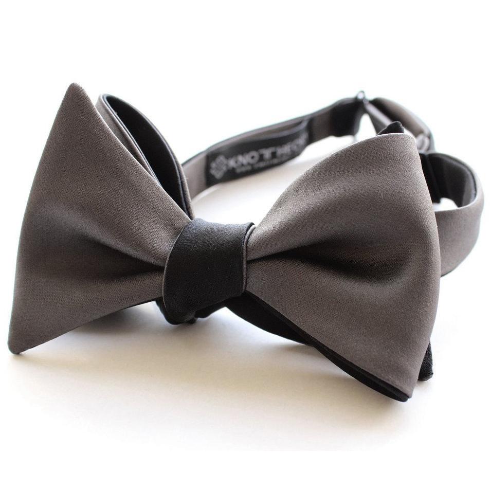 A sophisticated black and slate grey reversible butterfly bow tie, showcasing its elegant design and versatility.