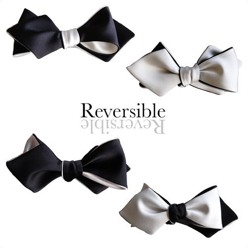 A stylish black and white diamond point bow tie, showcasing its elegant pattern and high-quality fabric.