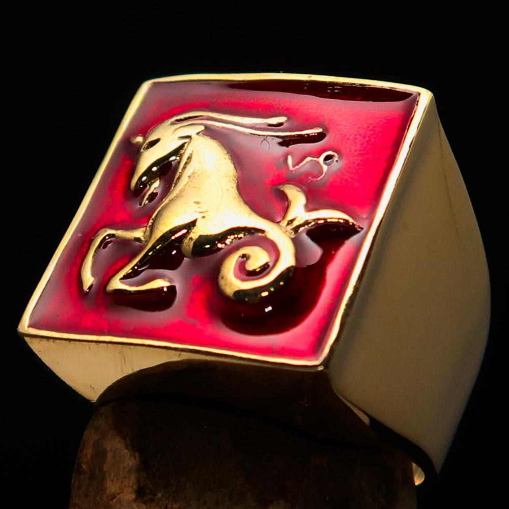 Brass Men's Zodiac Ring featuring Capricorn design with vibrant red enamel finish, showcasing its polished surface and astrological symbol.