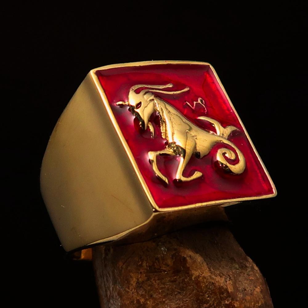 Brass Men's Zodiac Ring featuring Capricorn design with vibrant red enamel finish, showcasing its polished surface and astrological symbol.