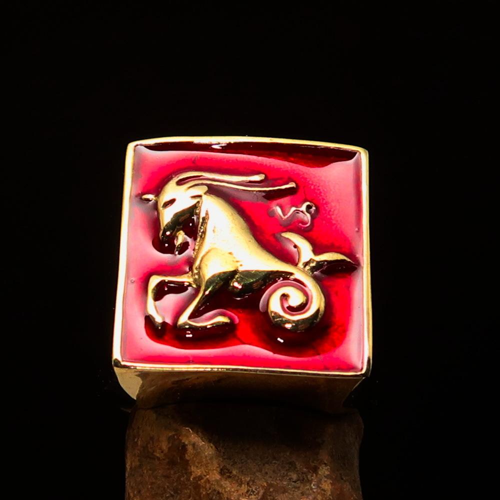 Brass Men's Zodiac Ring featuring Capricorn design with vibrant red enamel finish, showcasing its polished surface and astrological symbol.