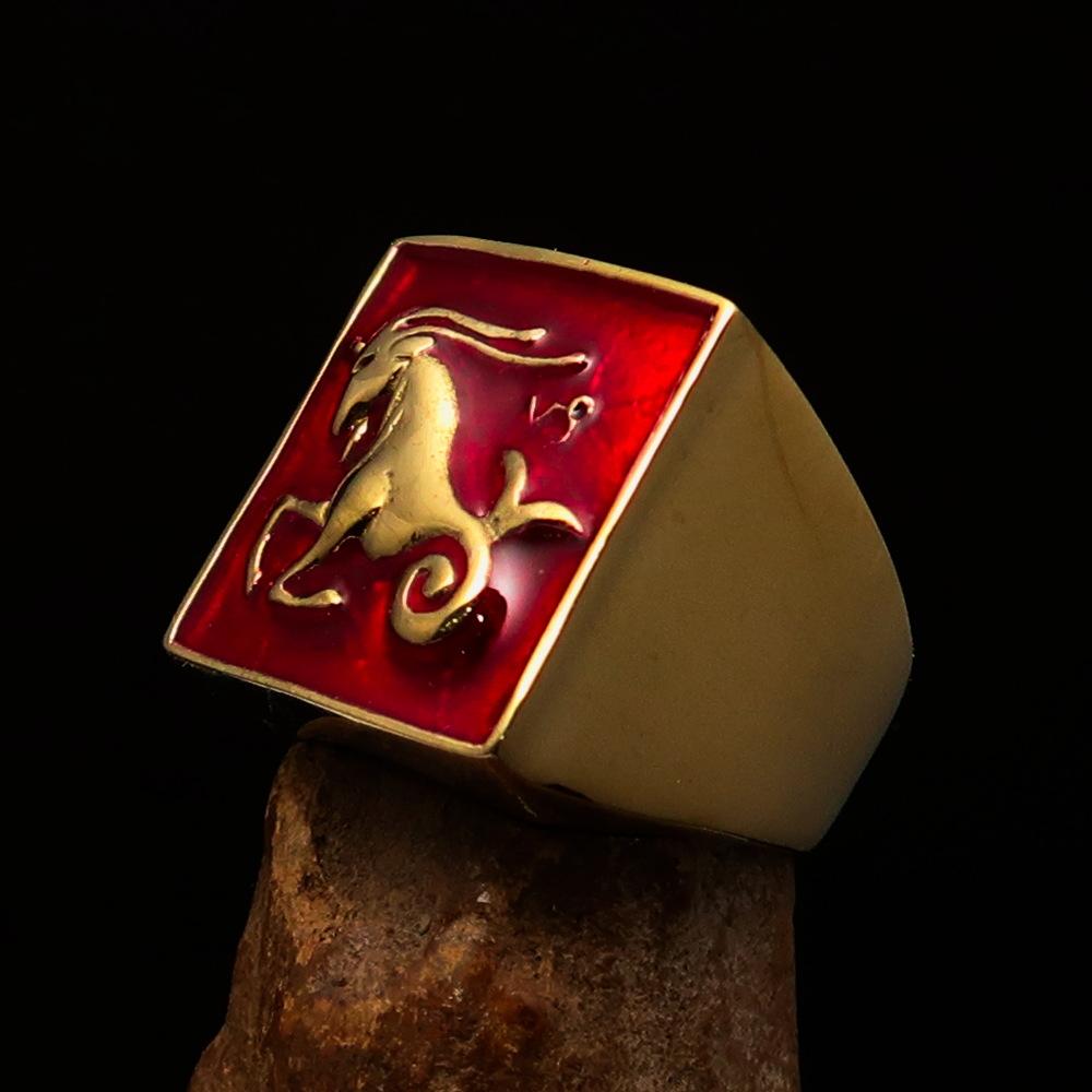 Brass Men's Zodiac Ring featuring Capricorn design with vibrant red enamel finish, showcasing its polished surface and astrological symbol.