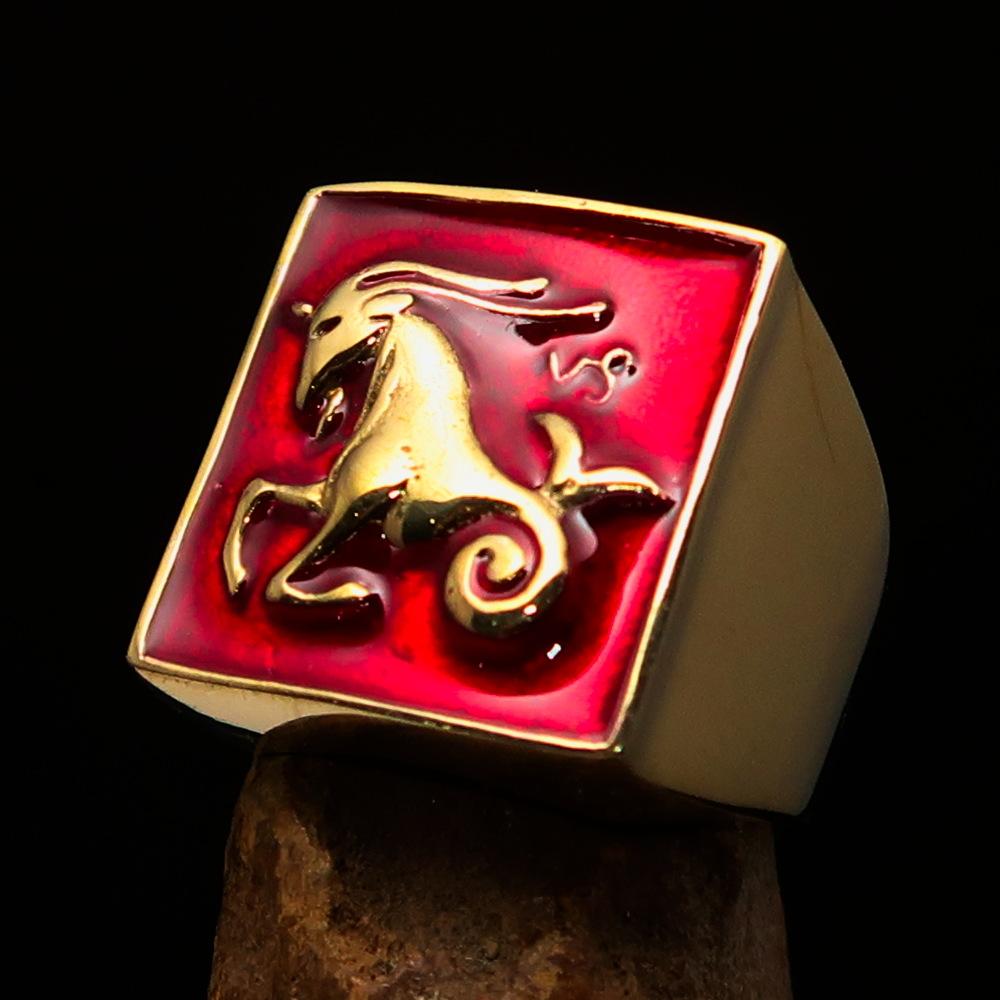 Brass Men's Zodiac Ring featuring Capricorn design with vibrant red enamel finish, showcasing its polished surface and astrological symbol.