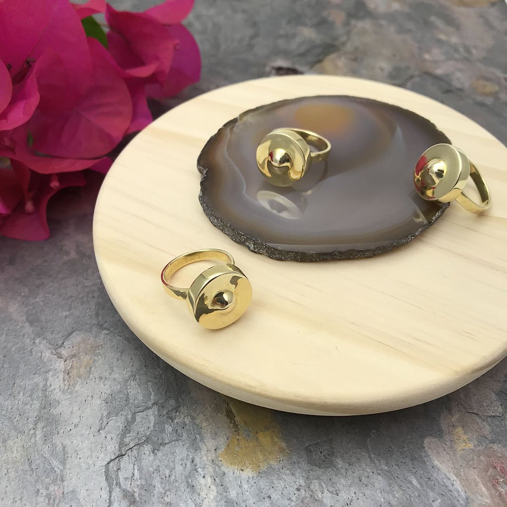 A beautifully crafted Cambodian Gong Ring made from recycled brass bombshells, showcasing its unique gong shape and polished finish.