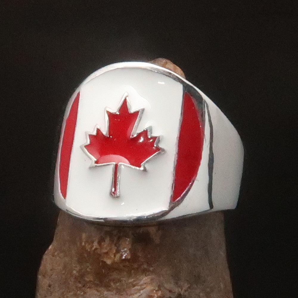 A beautifully crafted Canadian Flag Ring made of solid sterling silver with vibrant enamel detailing, showcasing the national flag of Canada.