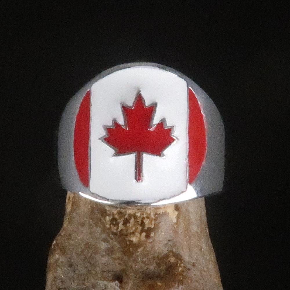 A beautifully crafted Canadian Flag Ring made of solid sterling silver with vibrant enamel detailing, showcasing the national flag of Canada.