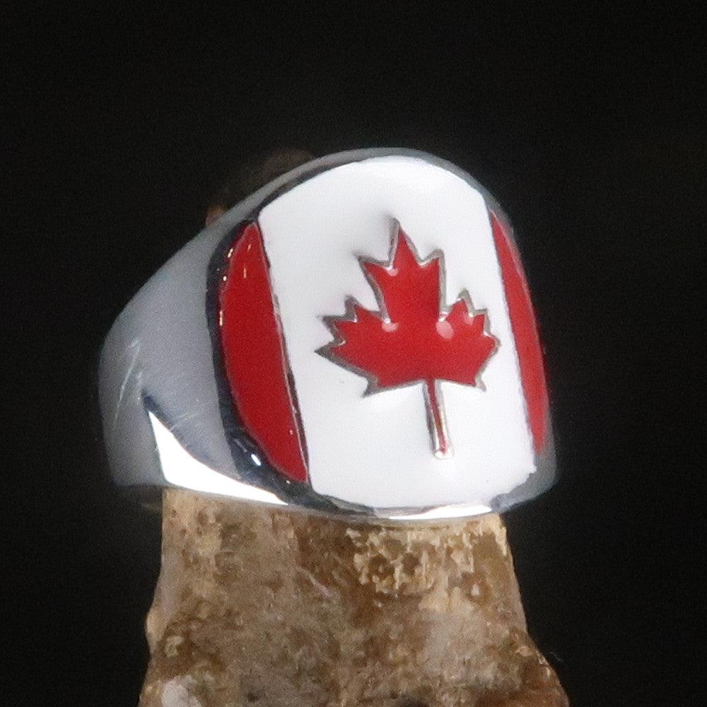 A beautifully crafted Canadian Flag Ring made of solid sterling silver with vibrant enamel detailing, showcasing the national flag of Canada.