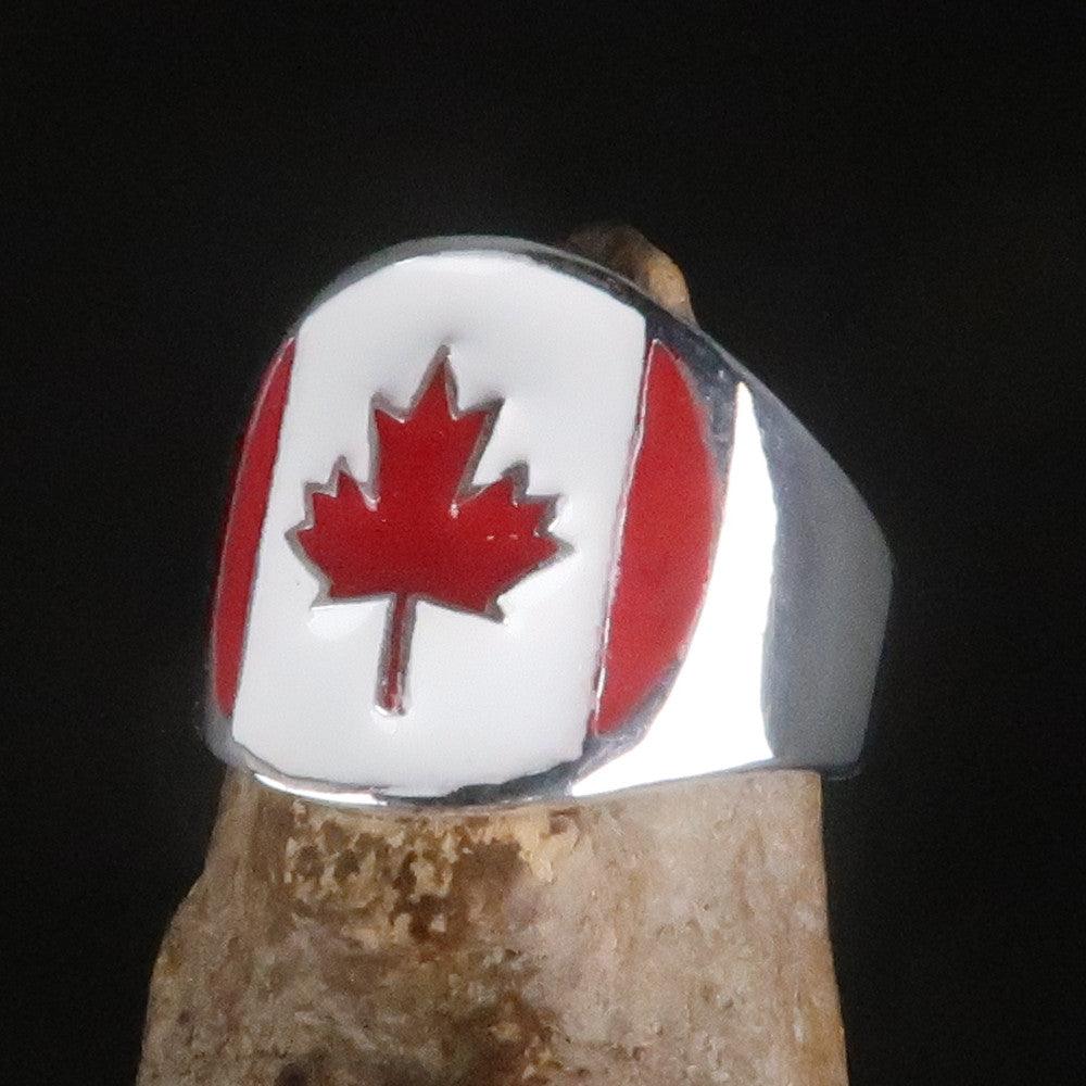 A beautifully crafted Canadian Flag Ring made of solid sterling silver with vibrant enamel detailing, showcasing the national flag of Canada.