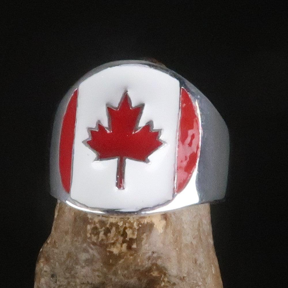 A beautifully crafted Canadian Flag Ring made of solid sterling silver with vibrant enamel detailing, showcasing the national flag of Canada.