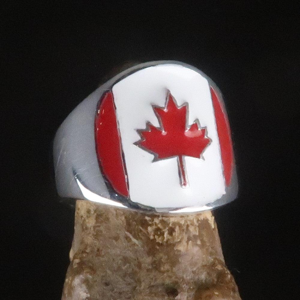 A beautifully crafted Canadian Flag Ring made of solid sterling silver with vibrant enamel detailing, showcasing the national flag of Canada.