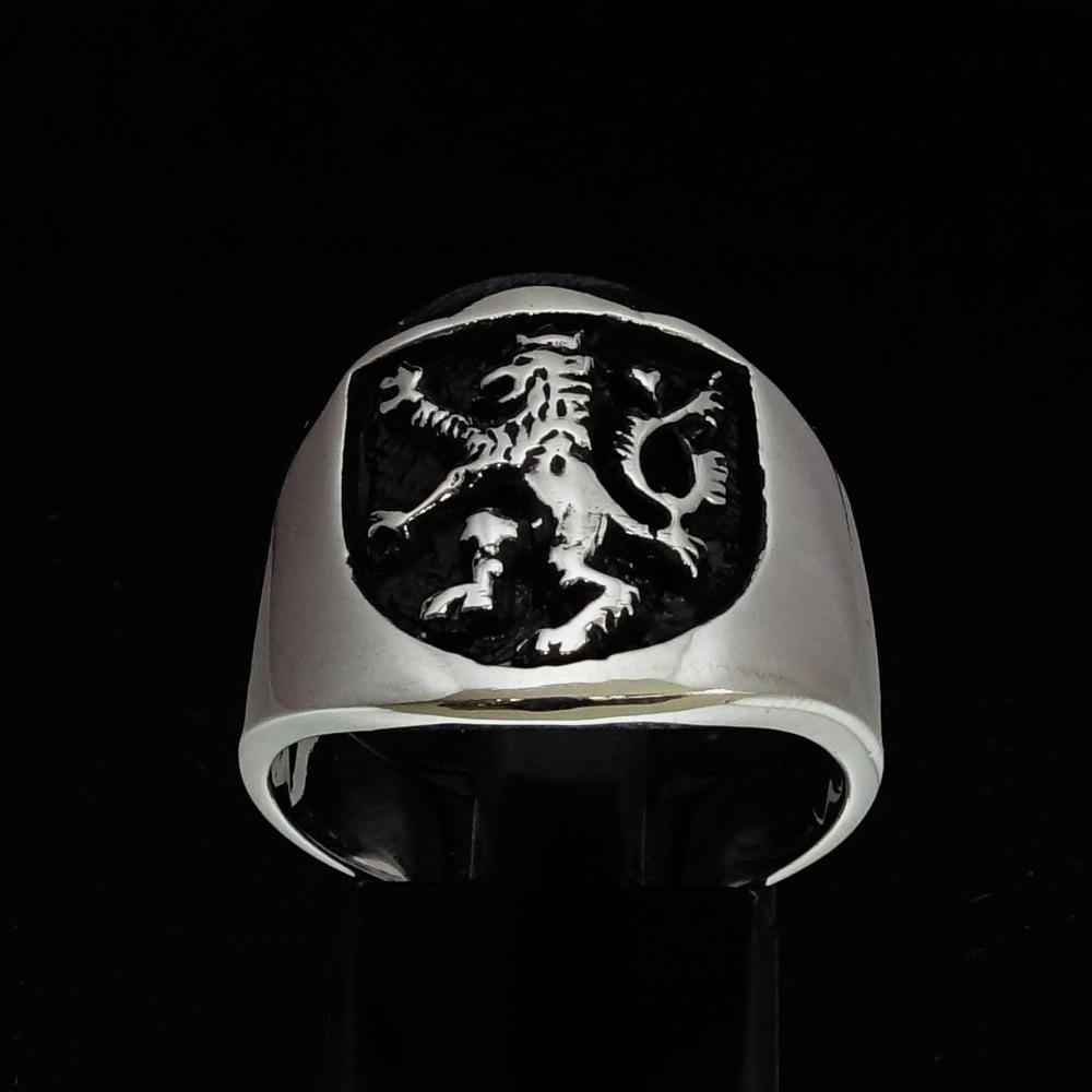 A beautifully crafted ancient Men's Rampant Lion Ring made of sterling silver with a black enamel finish, showcasing intricate details.