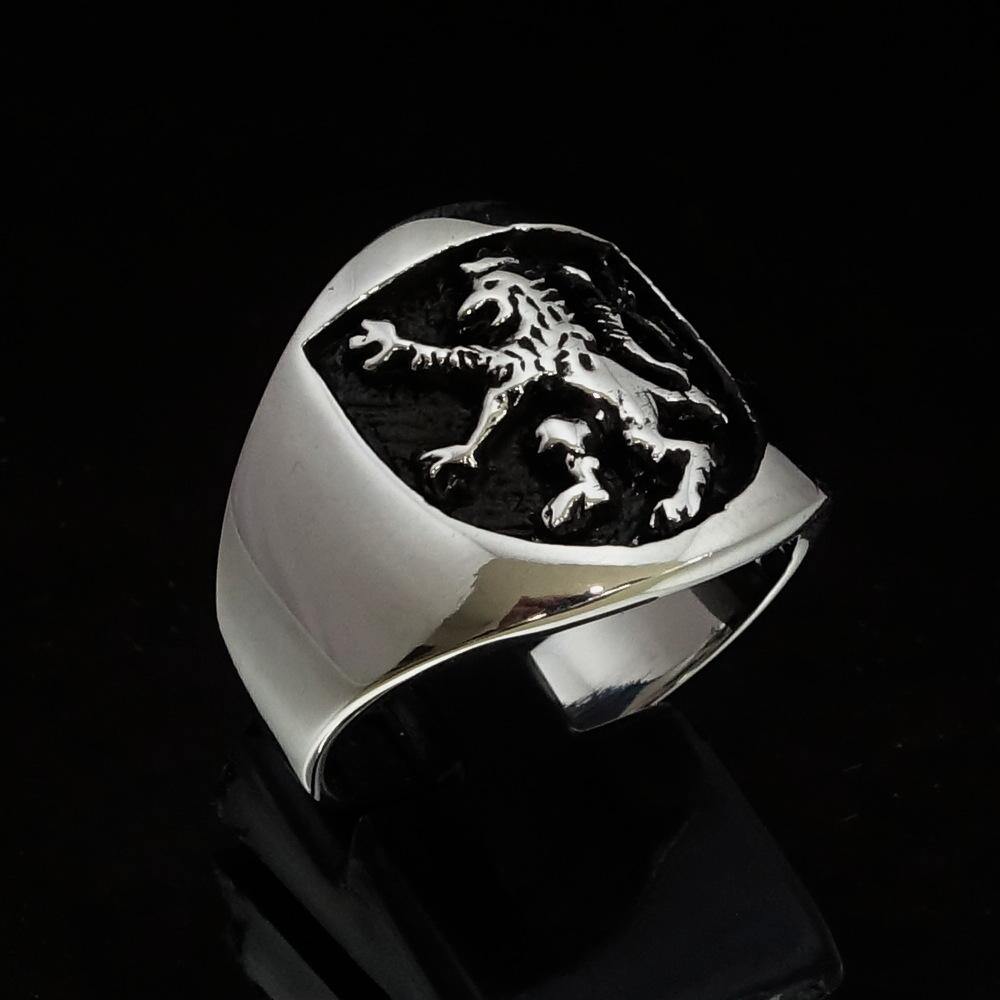 A beautifully crafted ancient Men's Rampant Lion Ring made of sterling silver with a black enamel finish, showcasing intricate details.