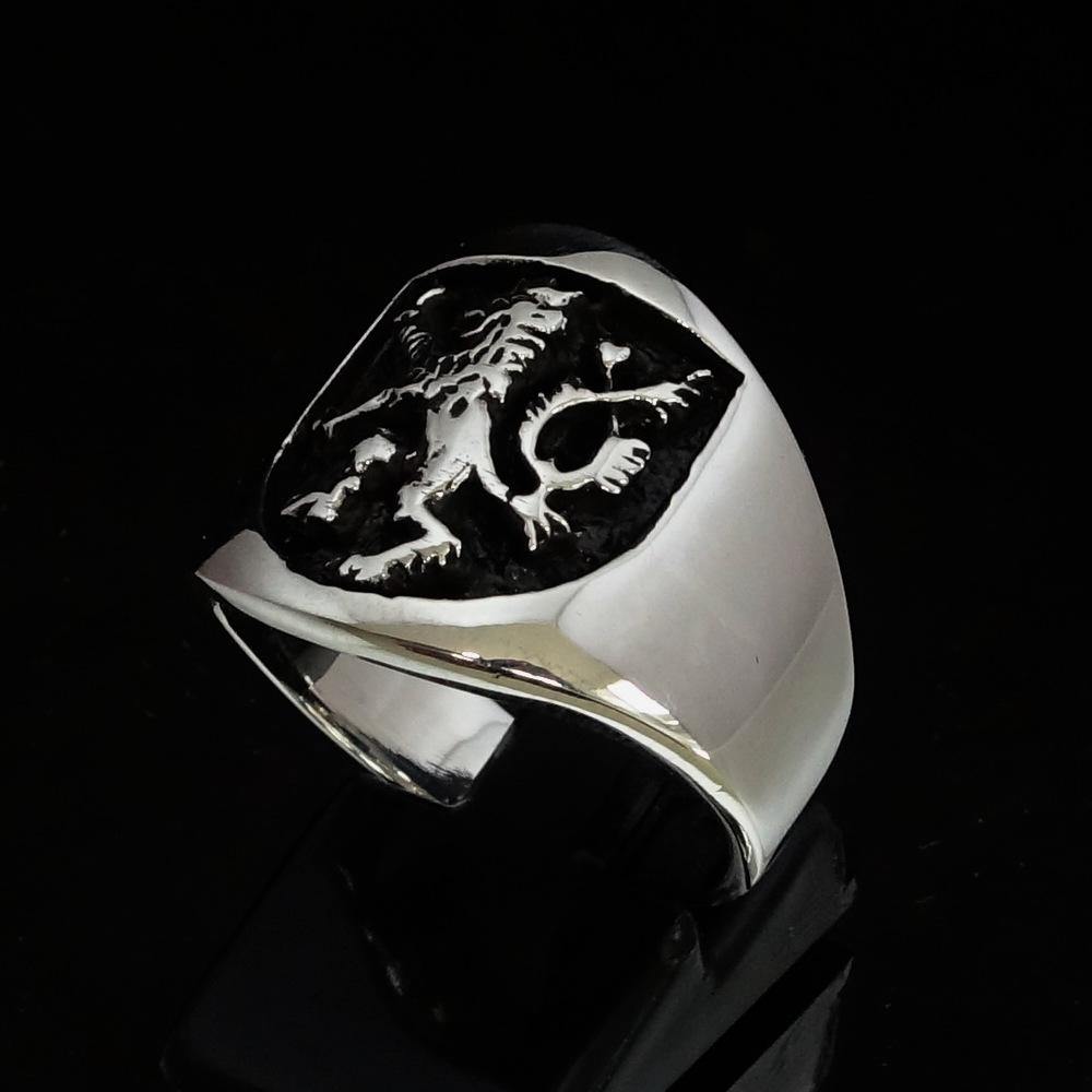 A beautifully crafted ancient Men's Rampant Lion Ring made of sterling silver with a black enamel finish, showcasing intricate details.