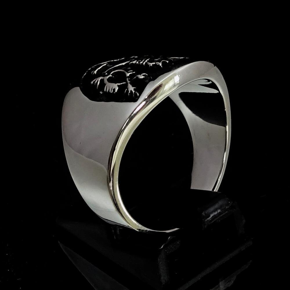 A beautifully crafted ancient Men's Rampant Lion Ring made of sterling silver with a black enamel finish, showcasing intricate details.