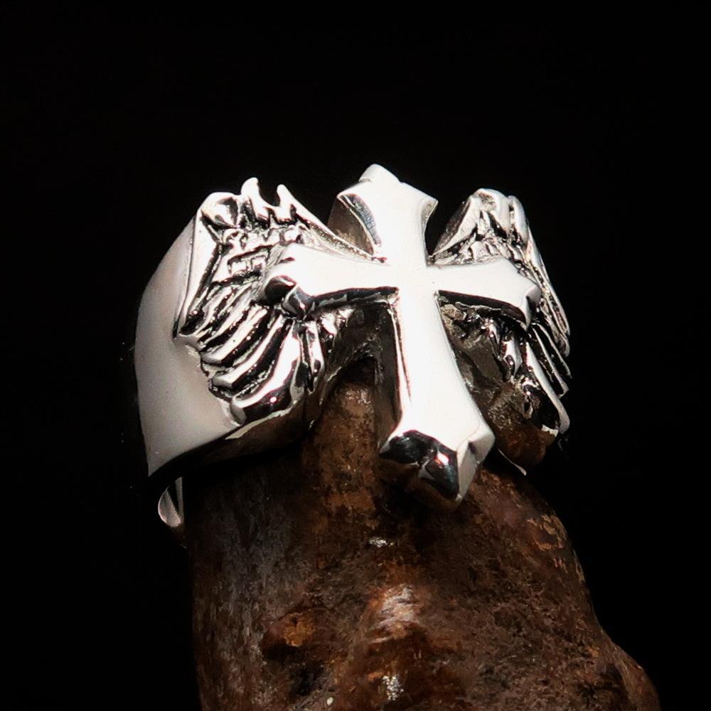 Antiqued sterling silver men's winged cross ring with high polish finish, showcasing intricate details and craftsmanship.