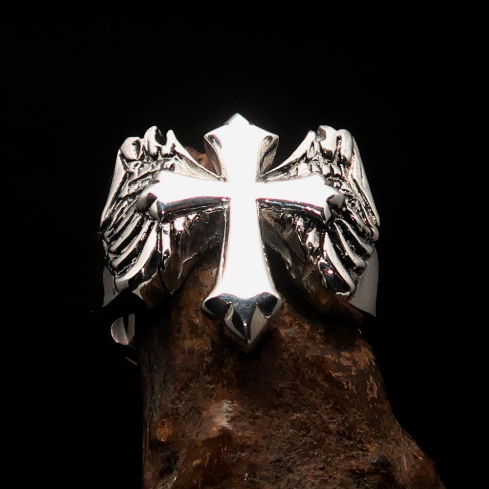 Antiqued sterling silver men's winged cross ring with high polish finish, showcasing intricate details and craftsmanship.