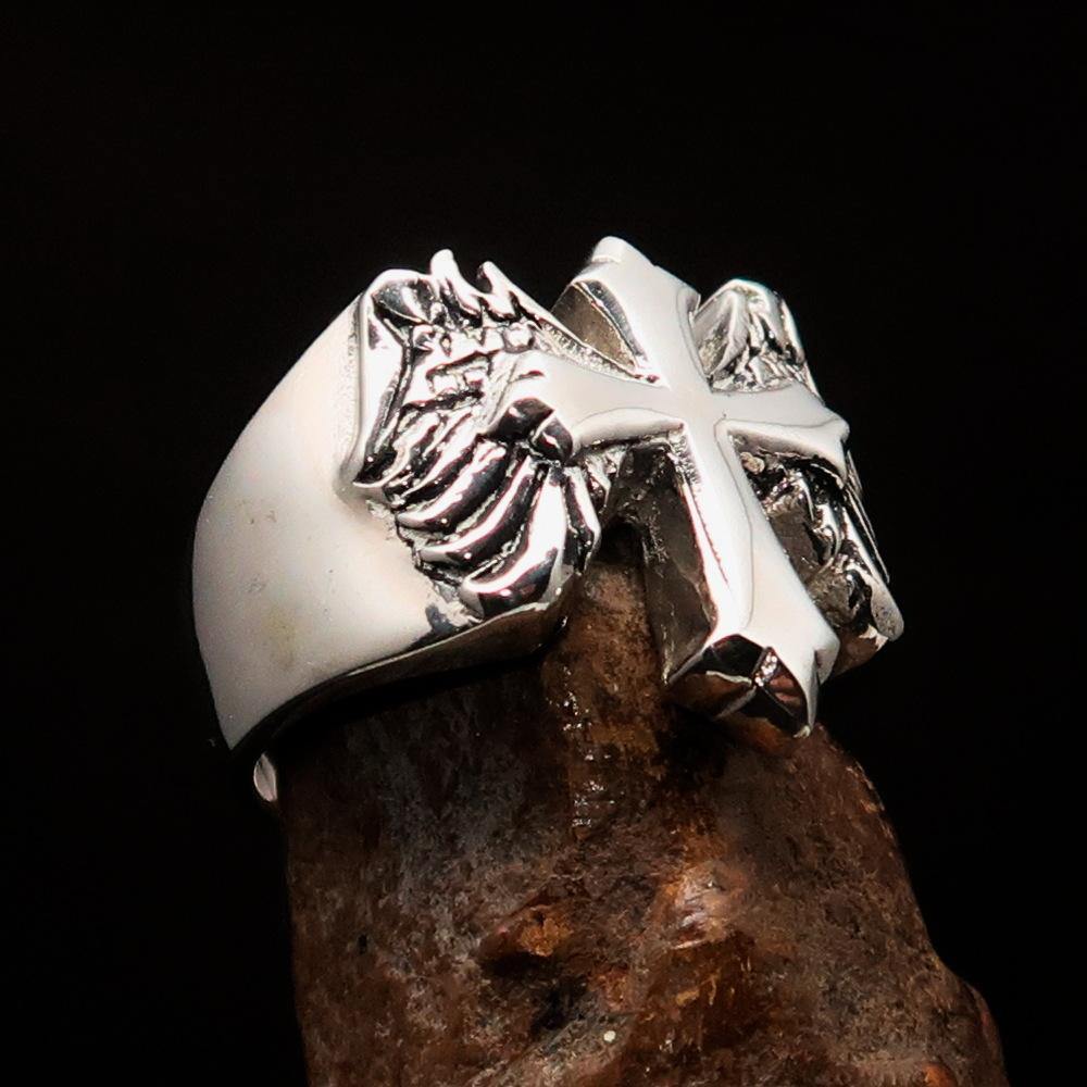 Antiqued sterling silver men's winged cross ring with high polish finish, showcasing intricate details and craftsmanship.